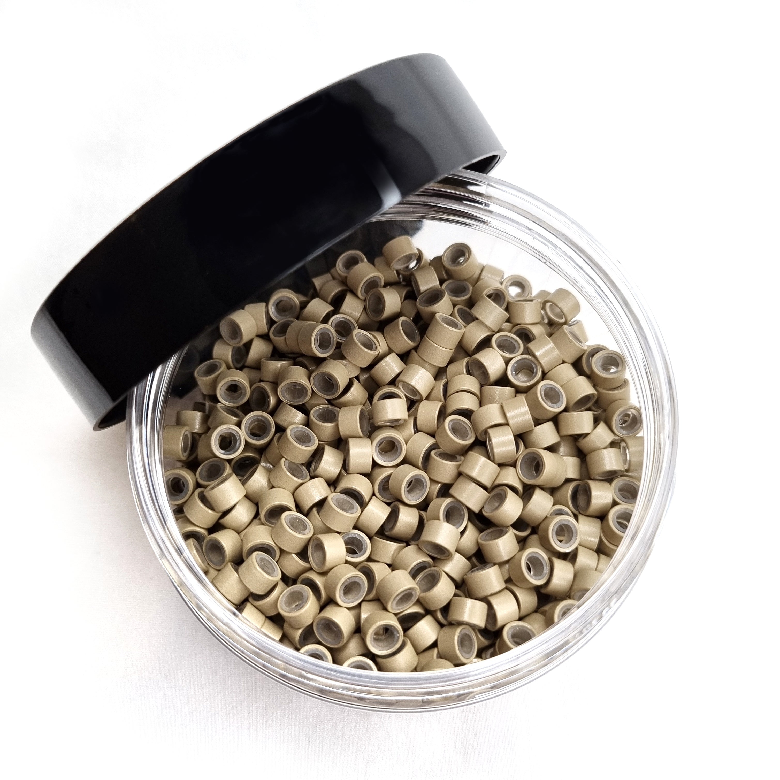 Salon professional silicon lined aluminium Blonde micro beads used as an anchor for weave hair extensions. The silicone lining provides extra grip and acts as a soft, protective layer between the bead and natural hair.