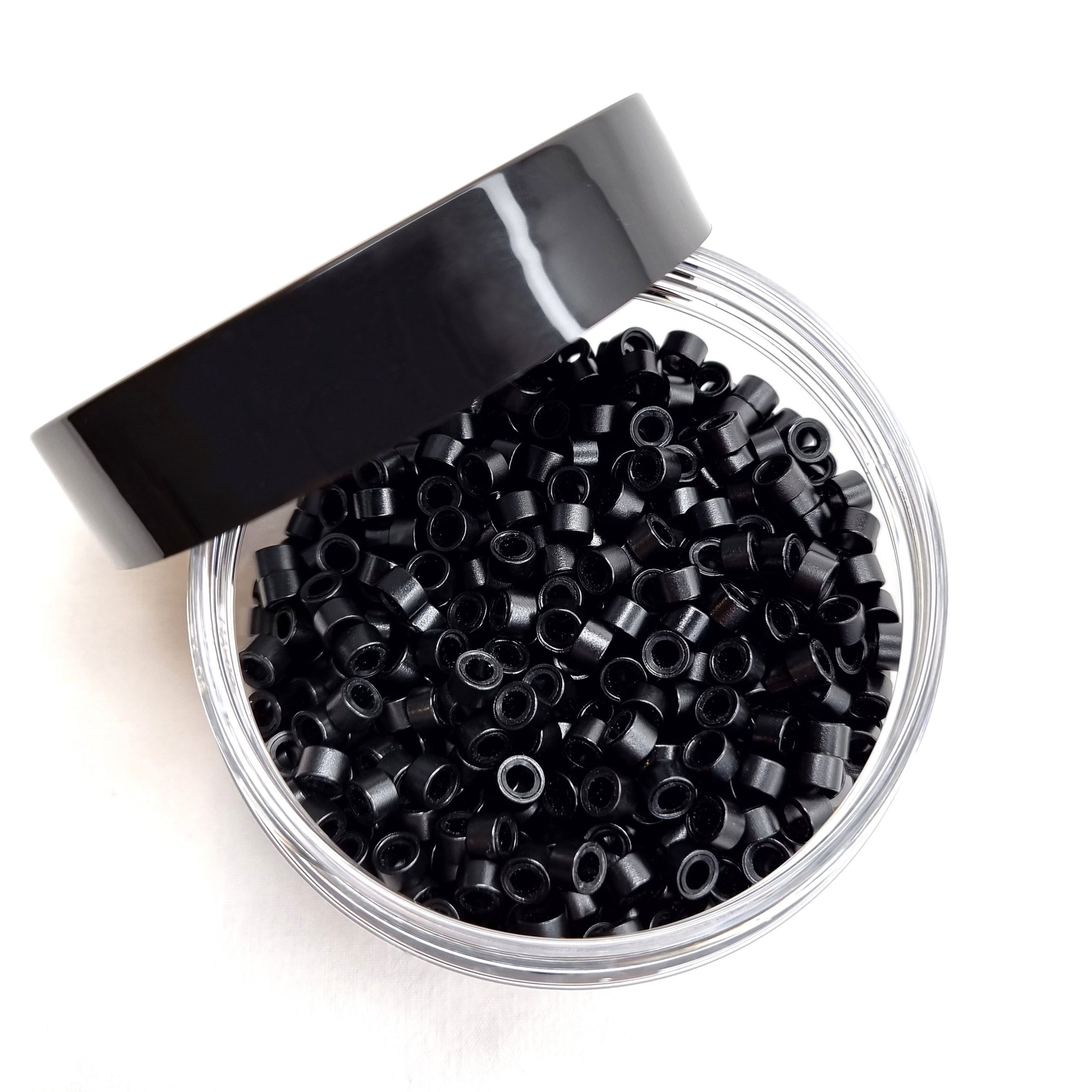 Salon professional silicon lined aluminium Black micro beads used as an anchor for weave hair extensions. The silicone lining provides extra grip and acts as a soft, protective layer between the bead and natural hair.