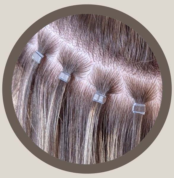 Hailie Hair beaded hair extensions (often called micro-bead, nano-ring, or i-tip extensions) are a damage-free, semi-permanent method that attaches extension strands or wefts to your natural hair using tiny, silicone-lined metal beads. 